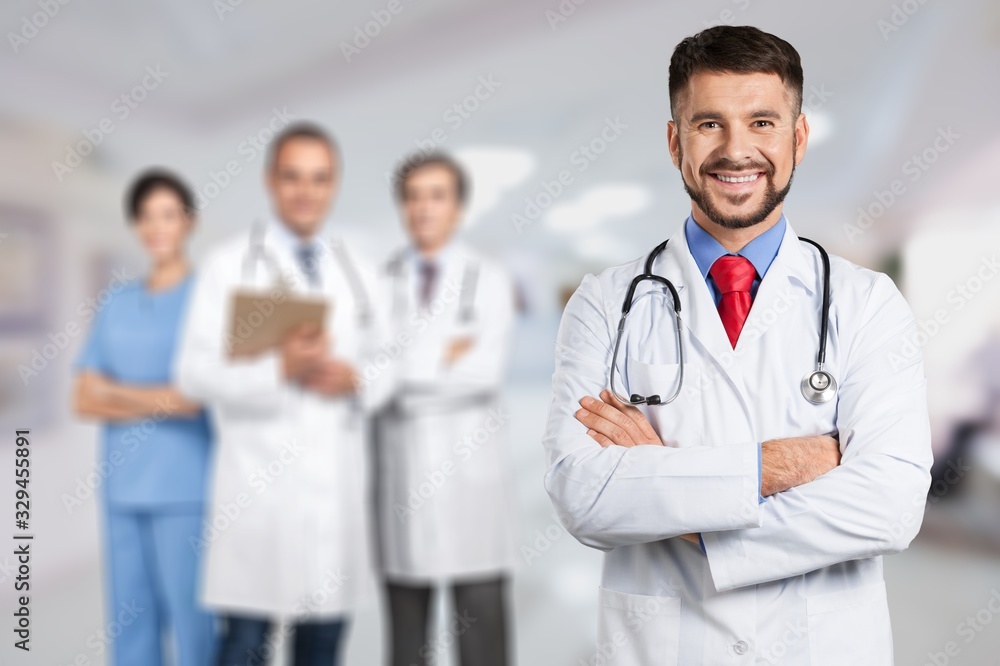 Handsome doctor portrait on hospital background