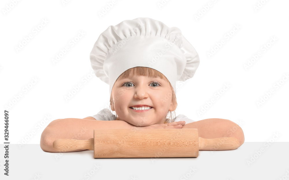 Cute little chef with rolling pin on white background