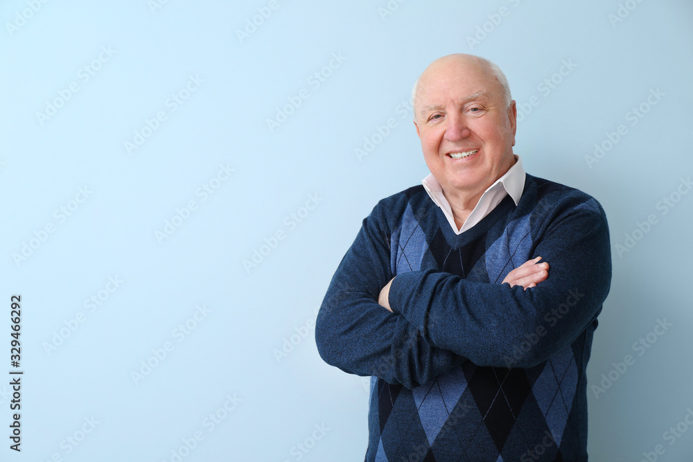 Portrait of elderly man on color background