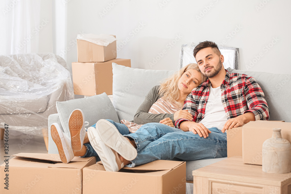 Couple with moving boxes in their new home