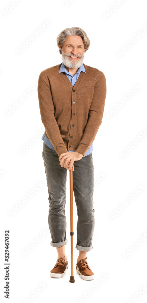 Stylish elderly man with walking stick on white background