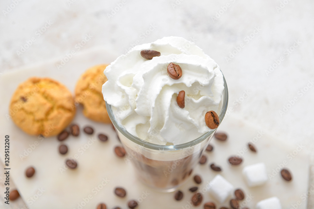 Glass of tasty iced coffee on table, closeup