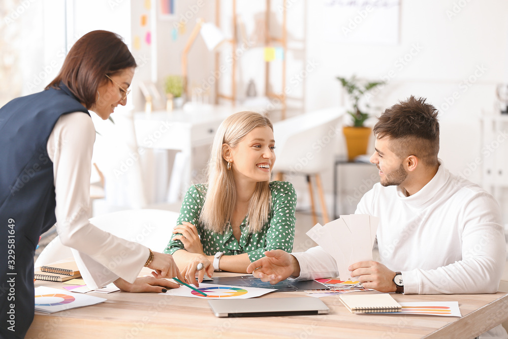 Female interior designer working with couple in office