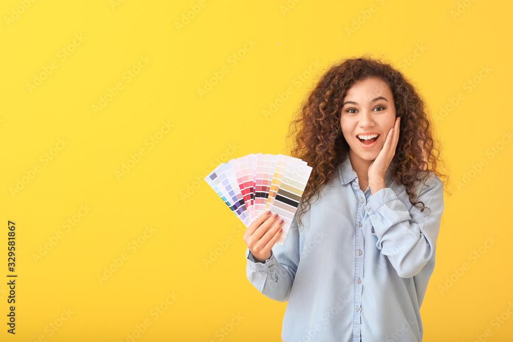 African-American woman with color palettes on yellow background