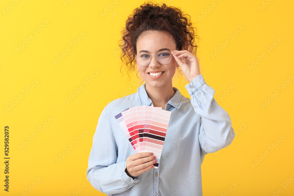 African-American woman with color palettes on yellow background