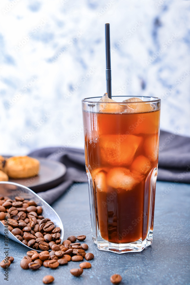 Glass of tasty iced coffee on table