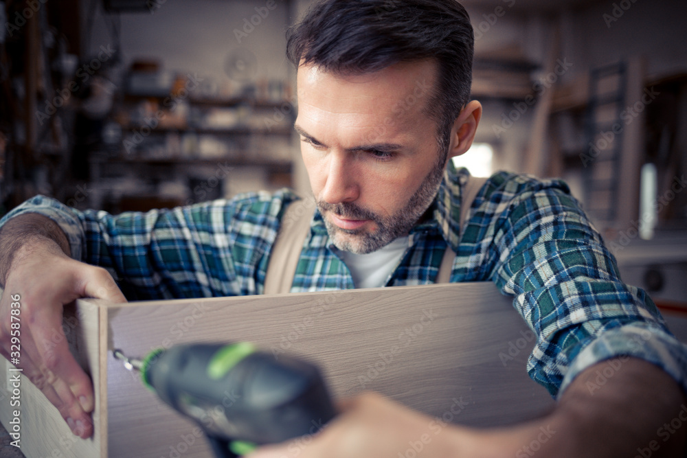 Carpenter working on woodworking in carpentry workshop