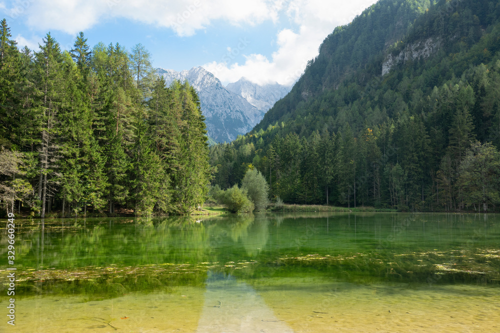 LOW ANGLE: Spectacular view of a rocky mountain overlooking the forest and lake.