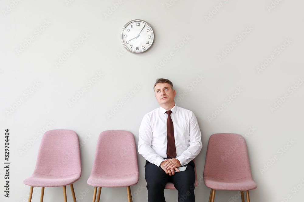 Mature man waiting for job interview indoors