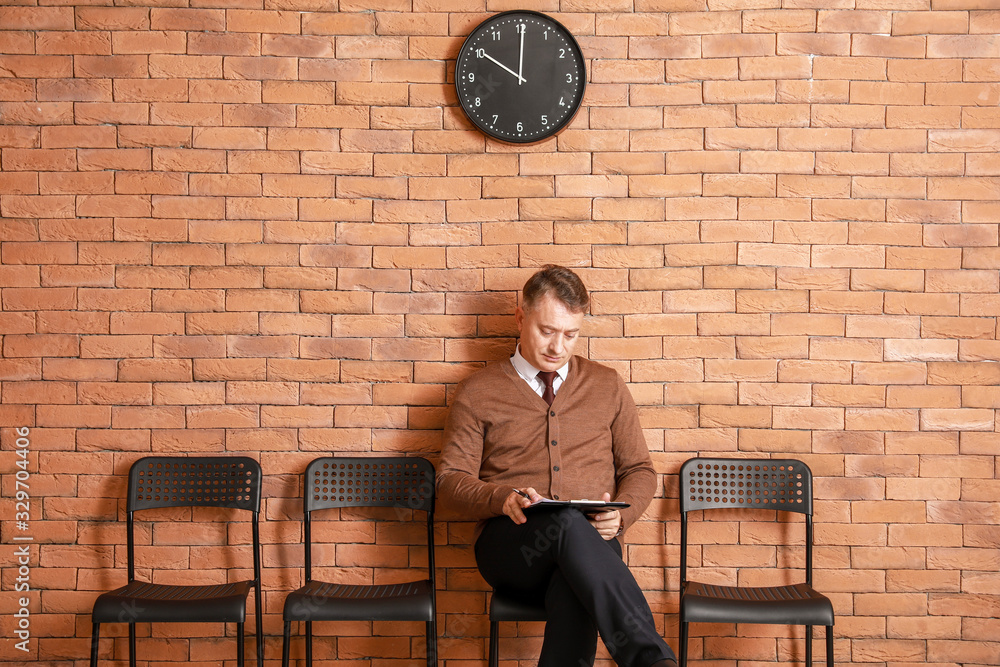 Mature man waiting for job interview indoors