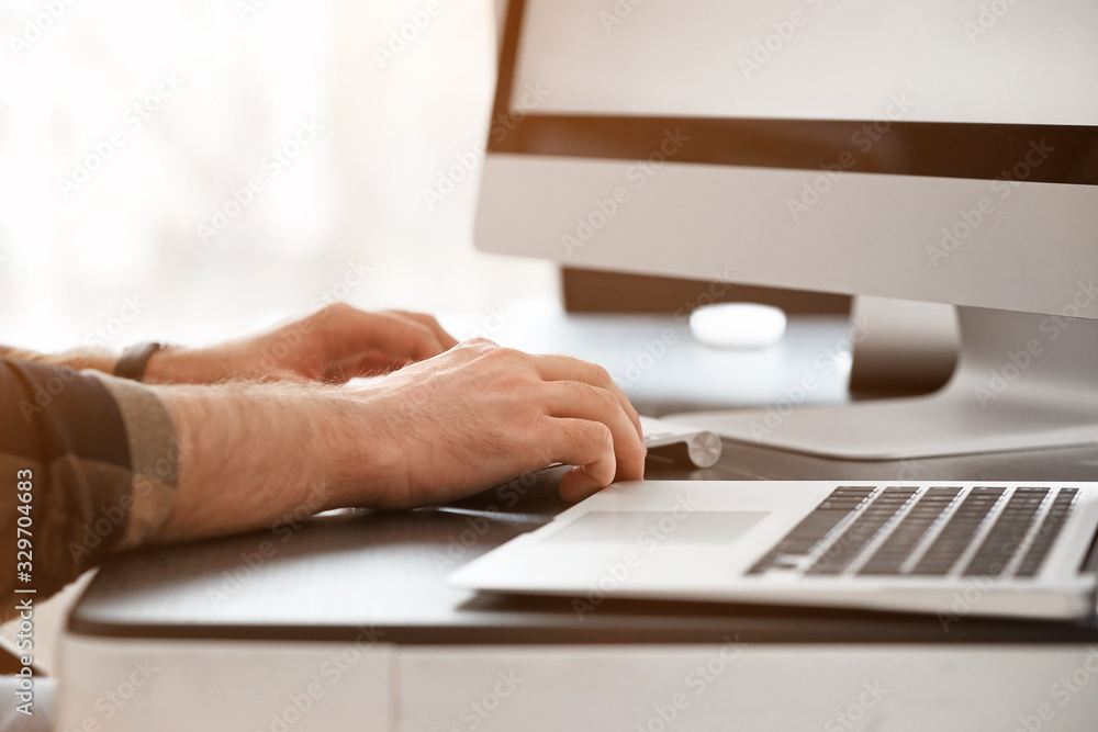 Male programmer working in office, closeup