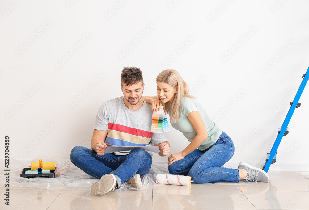 Young couple choosing color of wall