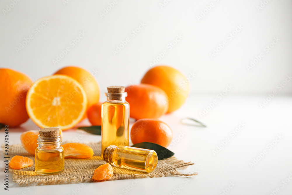 Bottles of citrus essential oil on table