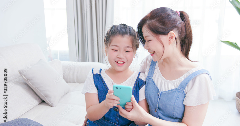 Daughters and mother use smartphone