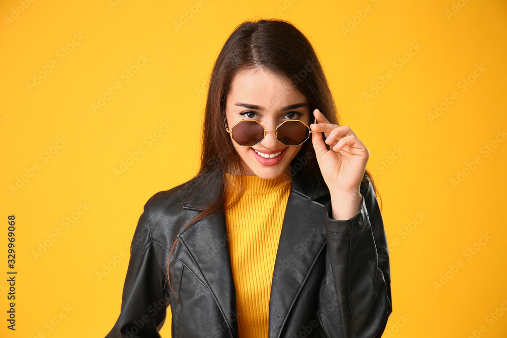 Stylish young woman on color background