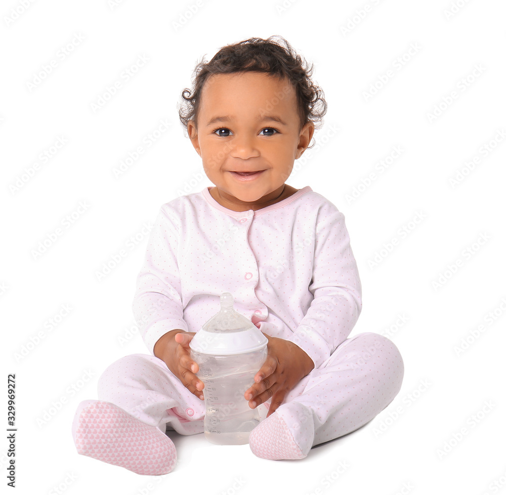 Cute African-American baby with bottle on white background