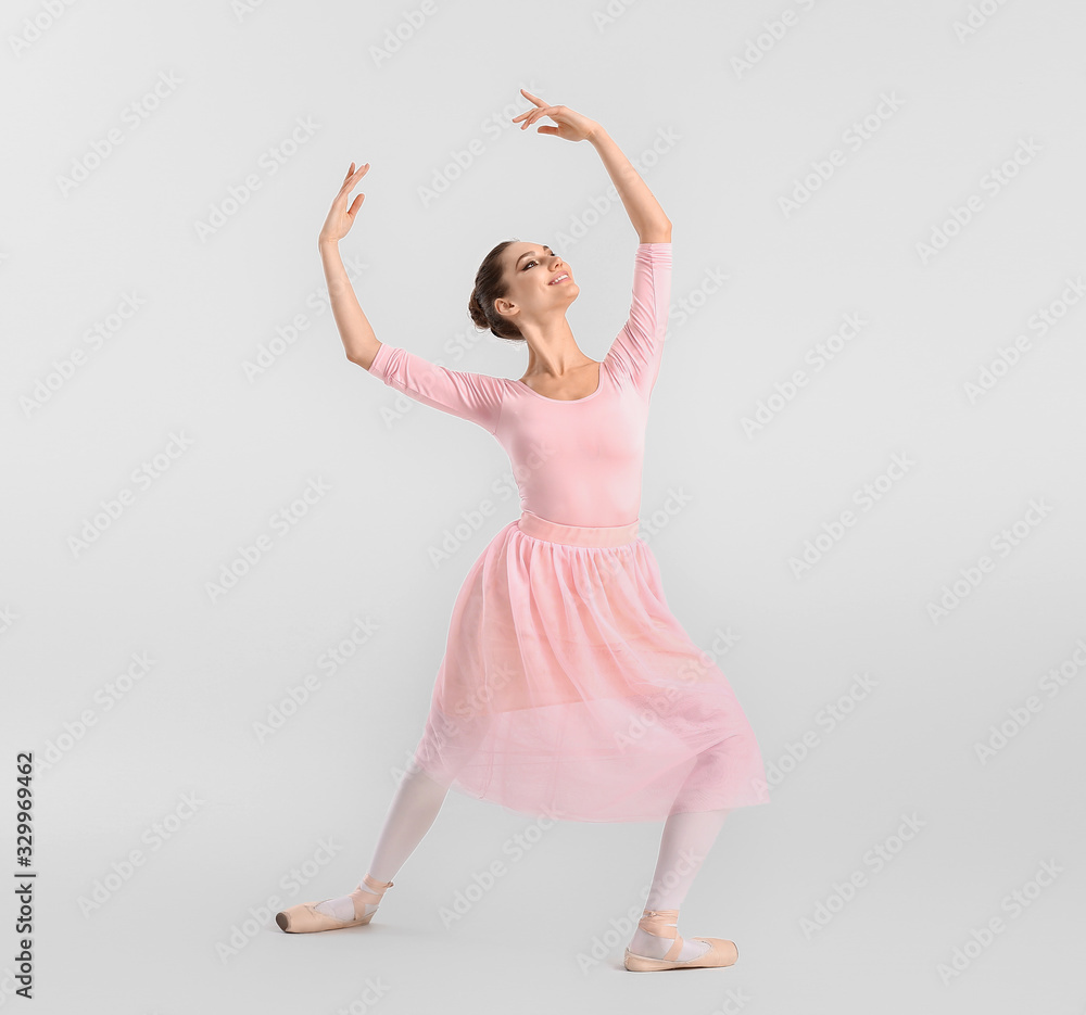 Beautiful young ballerina on white background