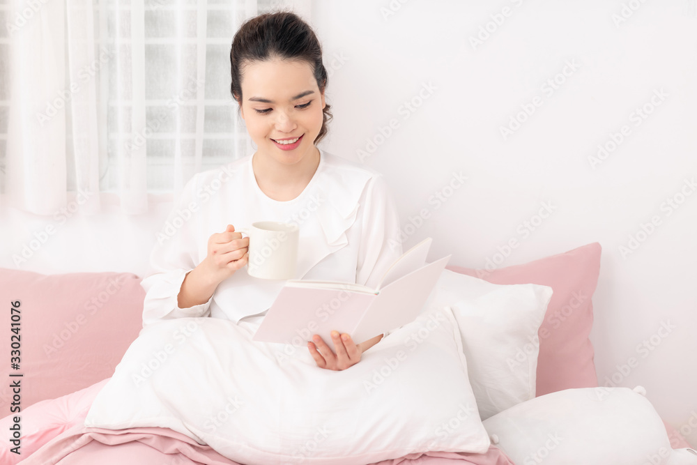 Amazing time to relax with favourite book and coffee. White bedroom shot