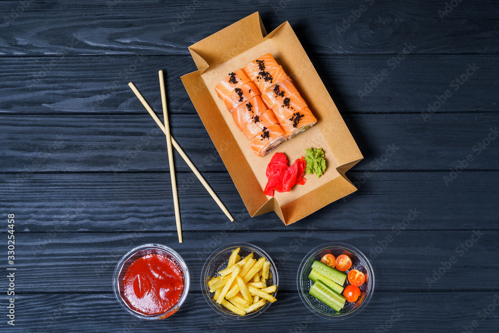 Food delivery, sushi rolls. Set of sushi in a cardboard box. Fast food