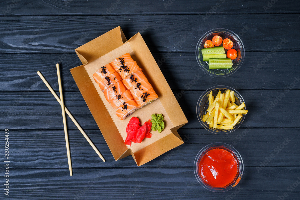 Food delivery, sushi rolls. Set of sushi in a cardboard box. Fast food