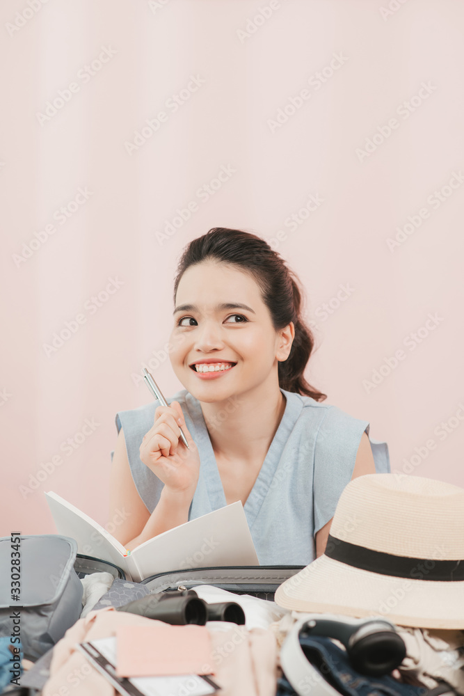 young asian pretty woman traveler prepare checking and packing clothes into suitcase for holiday vac