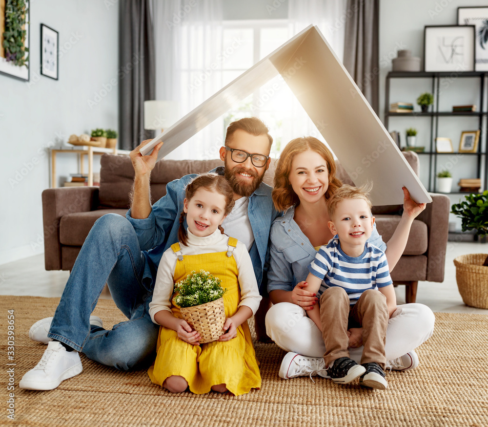 Happy family under fake roof in living room.