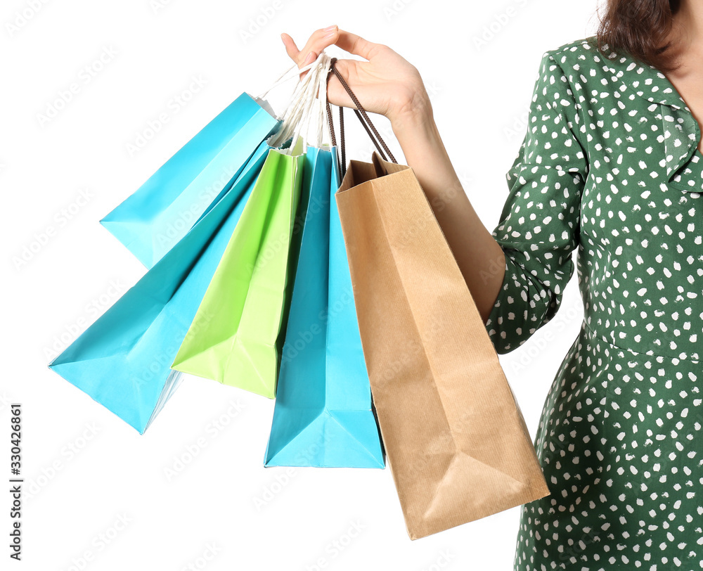 Beautiful young woman with shopping bags on white background