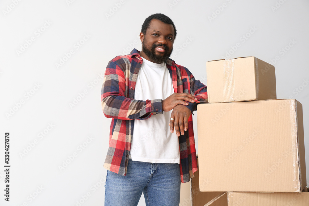 African-American man with boxes on white background