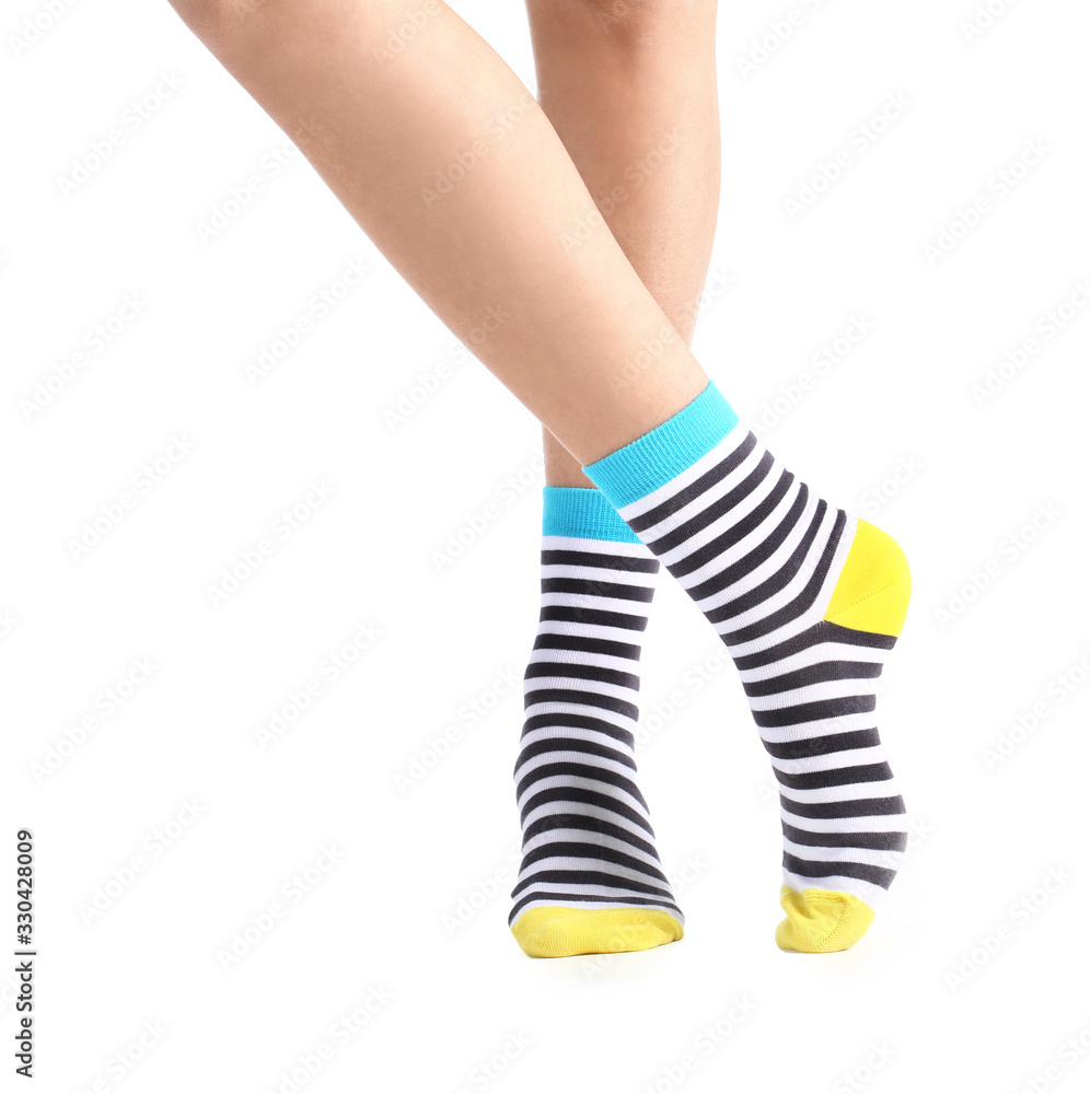 Legs of young woman in socks on white background