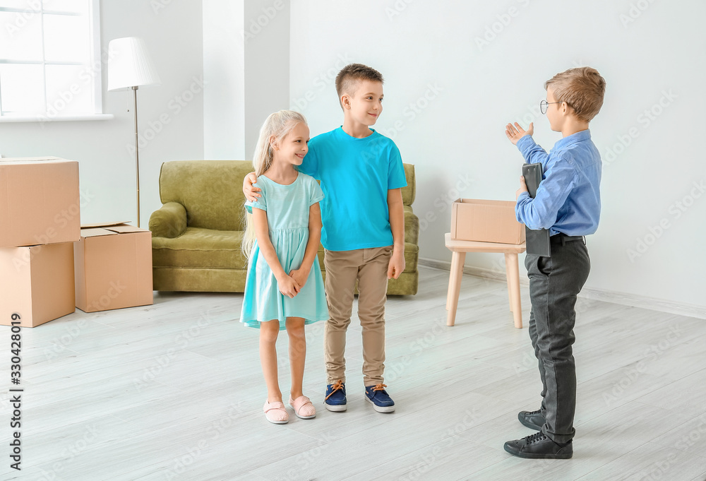 Little real estate agent showing clients a new house