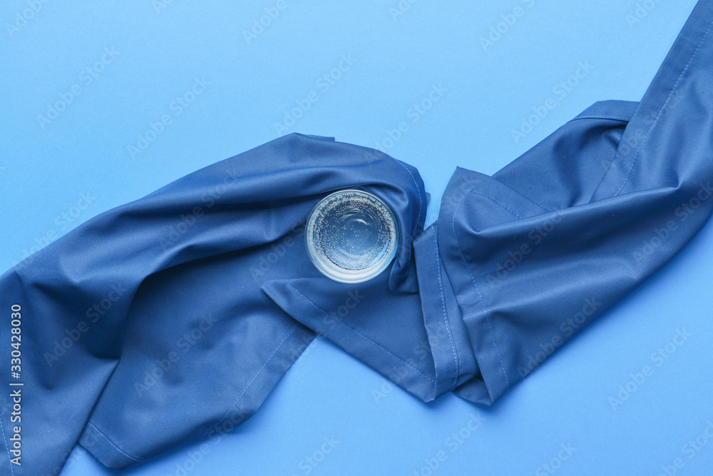 Glass of clean water on color background