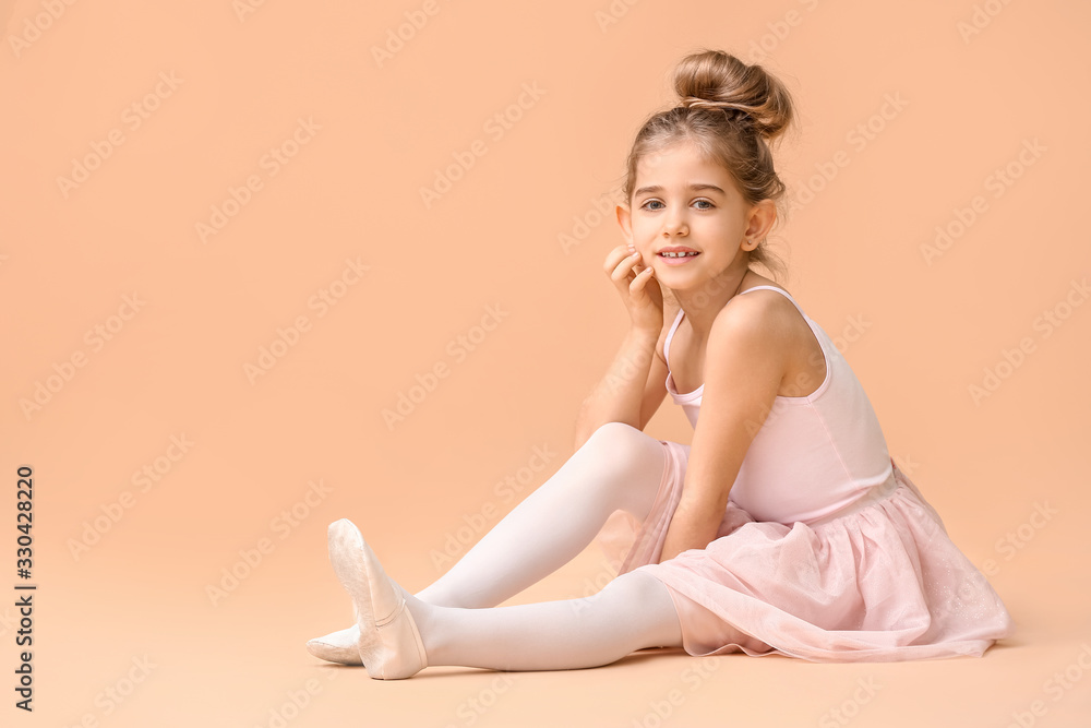 Cute little ballerina on color background