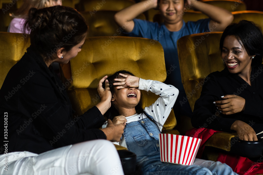 The girls cried loudly in the cinema, causing annoyance to the people sitting next to and behind the