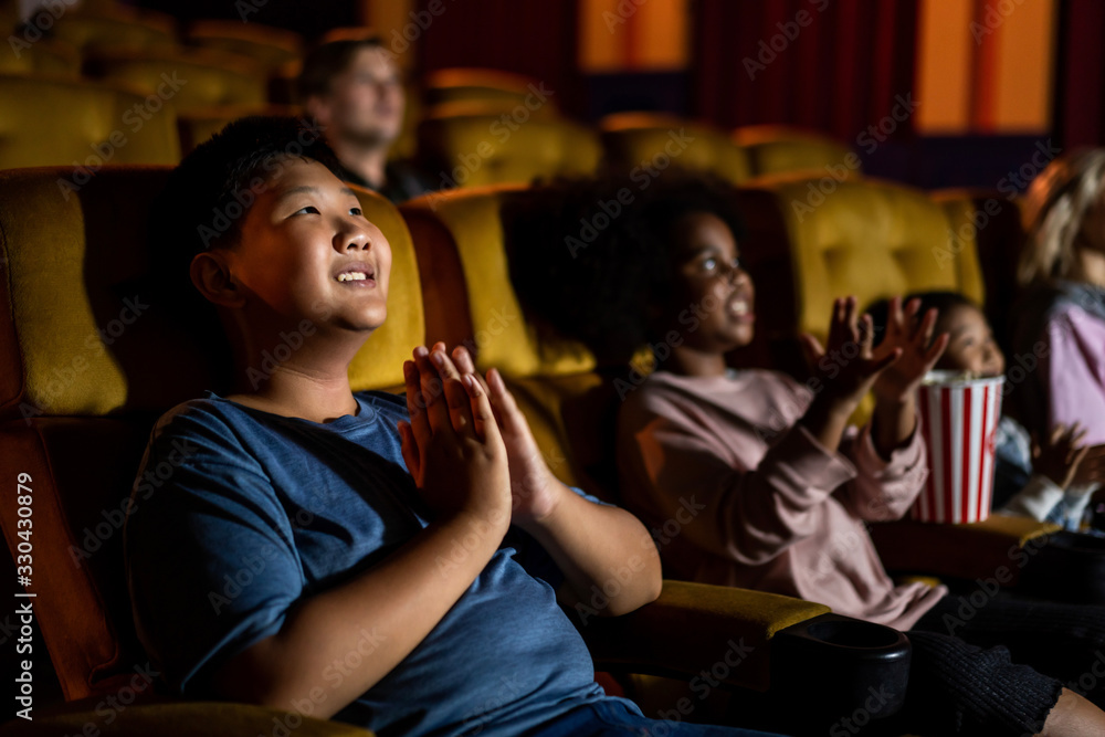 People audience watching movie in the movie theater cinema. Group recreation activity and entertainm