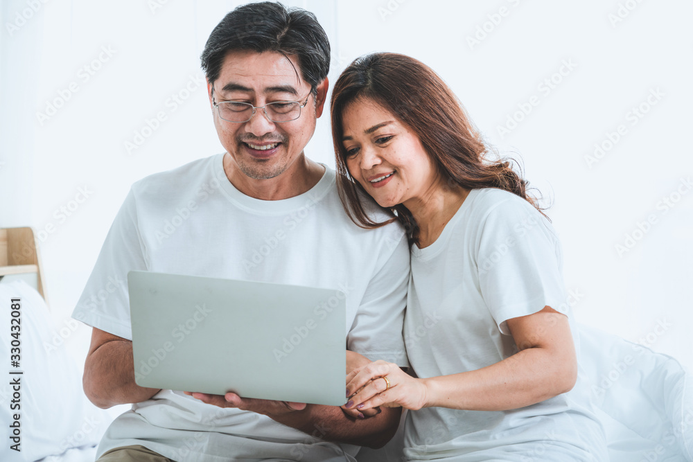 Happy Asian senior couple having good time at home. Old people retirement and healthy citizens elder