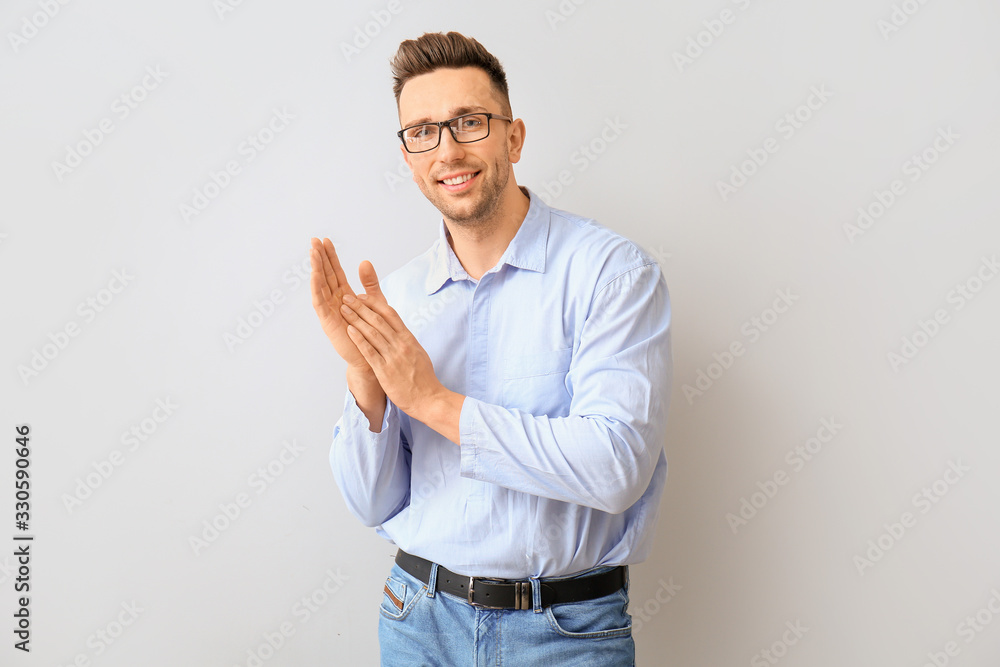 Portrait of handsome young man on light background