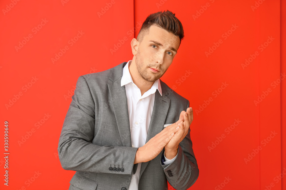 Portrait of handsome young man on color background