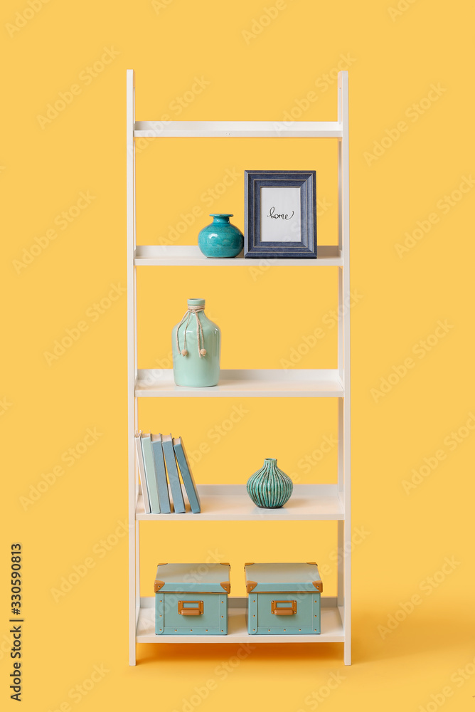 Shelving unit with decor on color background