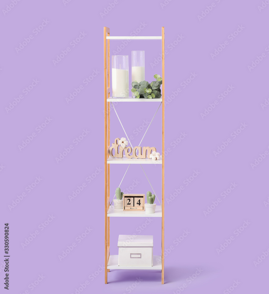 Shelving unit with decor on color background