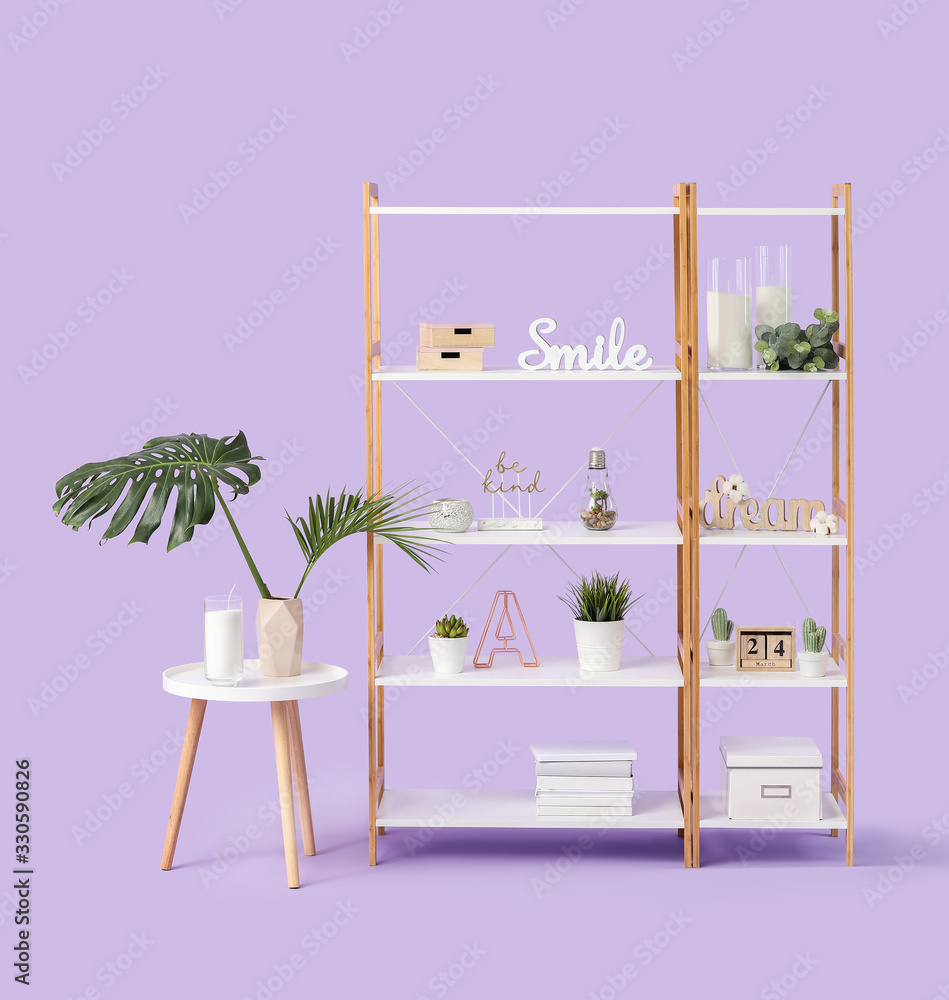 Shelving unit with decor on color background