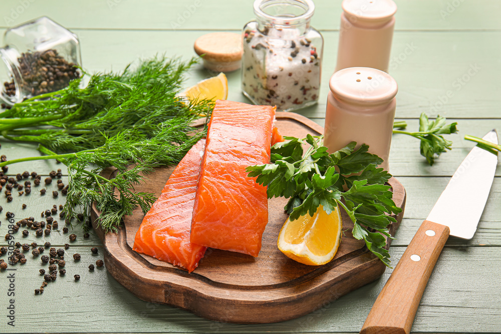 Raw salmon fillet with herbs and spices on table