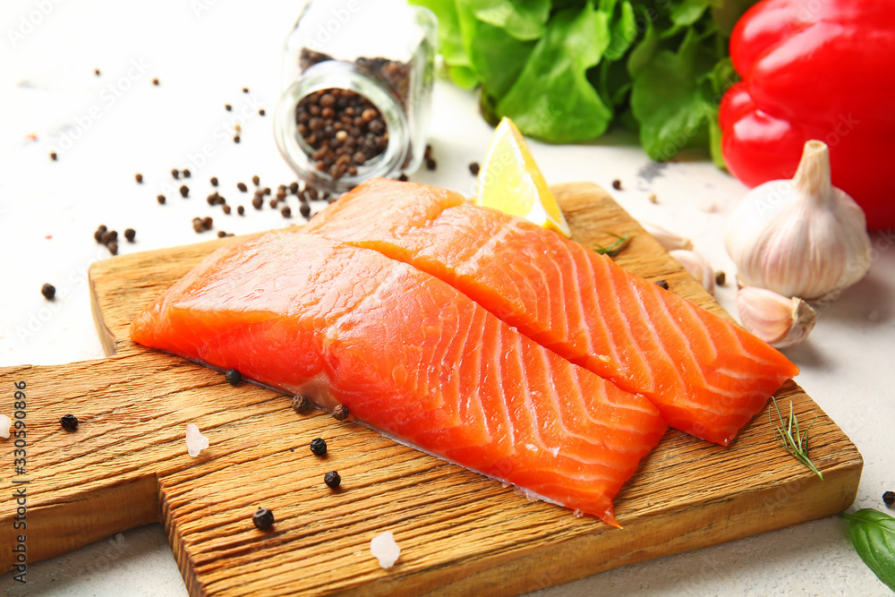 Raw salmon fillet with spices on table