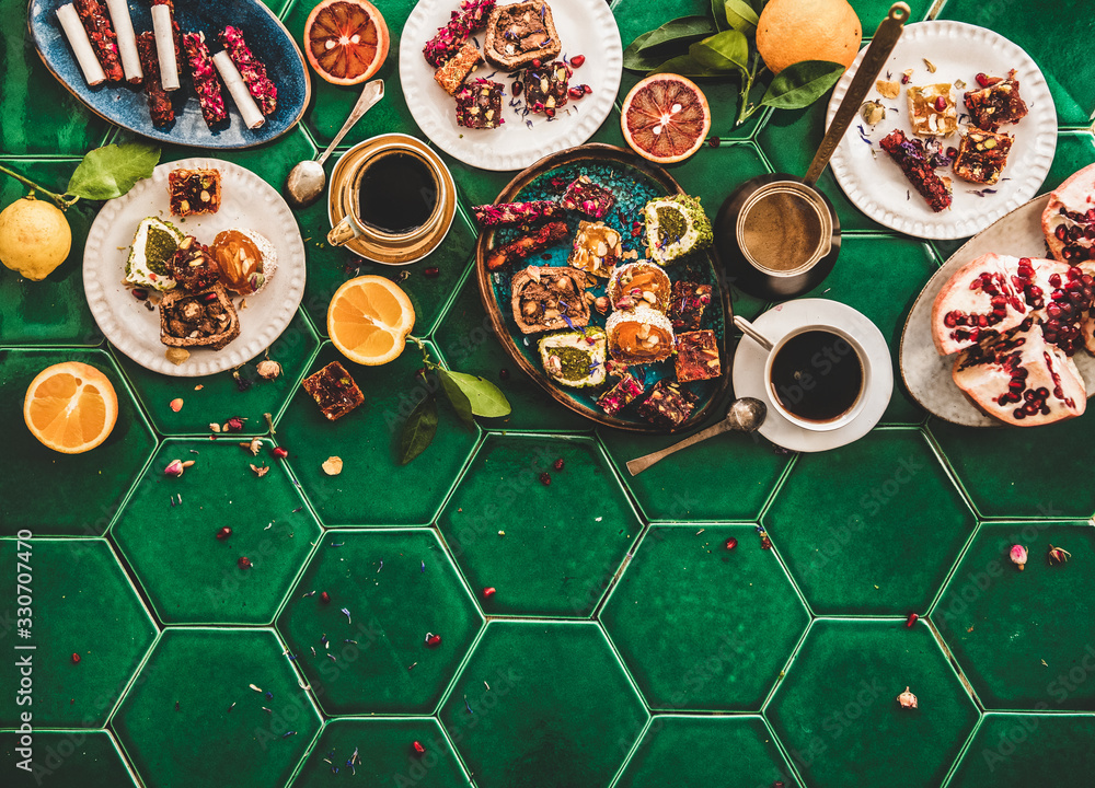 Flat-lay of variety of Turkish traditional lokum sweet delight with Turkish coffee in cups and fresh