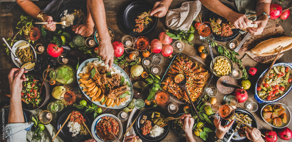 Flat-lay of family feasting with Turkish cuisine lamb chops, quince, bean, vegetable salad, babaganu