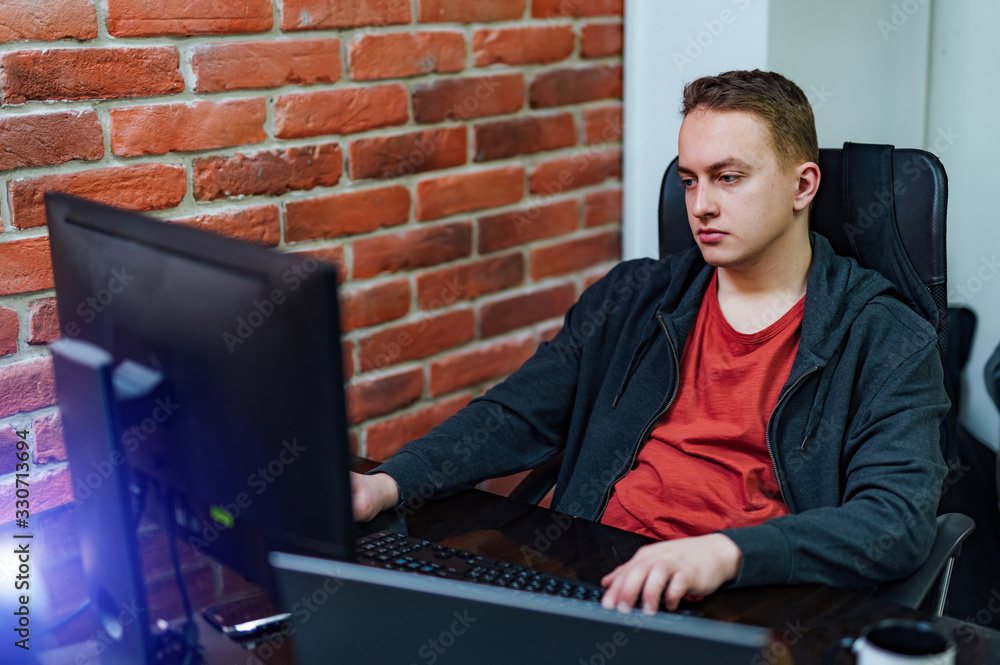 Man working at desk in creative office. Modern interior. Program development concept.