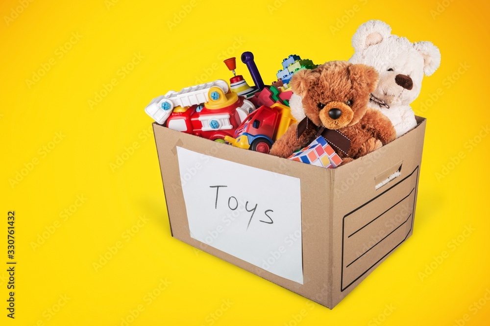 Toys collection in card box on a colored background