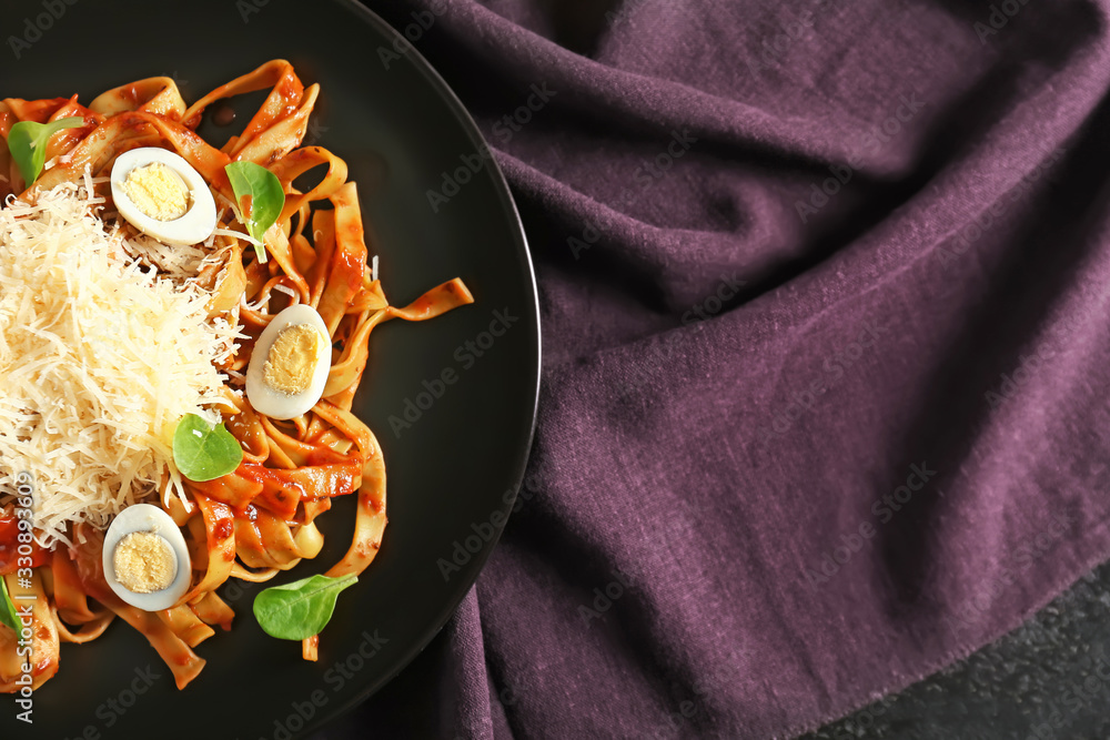 Plate with tasty pasta and cheese on table