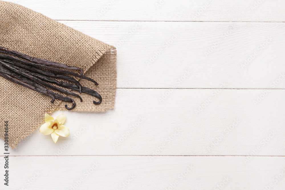 Aromatic vanilla sticks on white wooden background