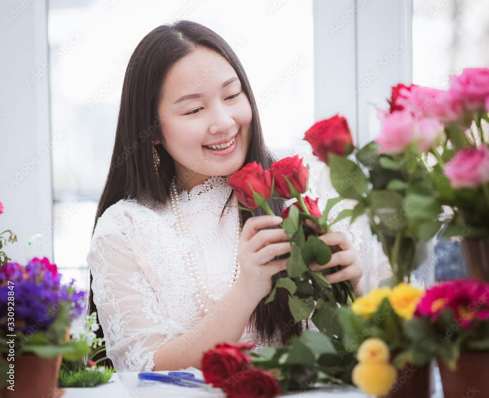 准备在家里修剪红色和粉色玫瑰以及美丽的插花的女人，花arr