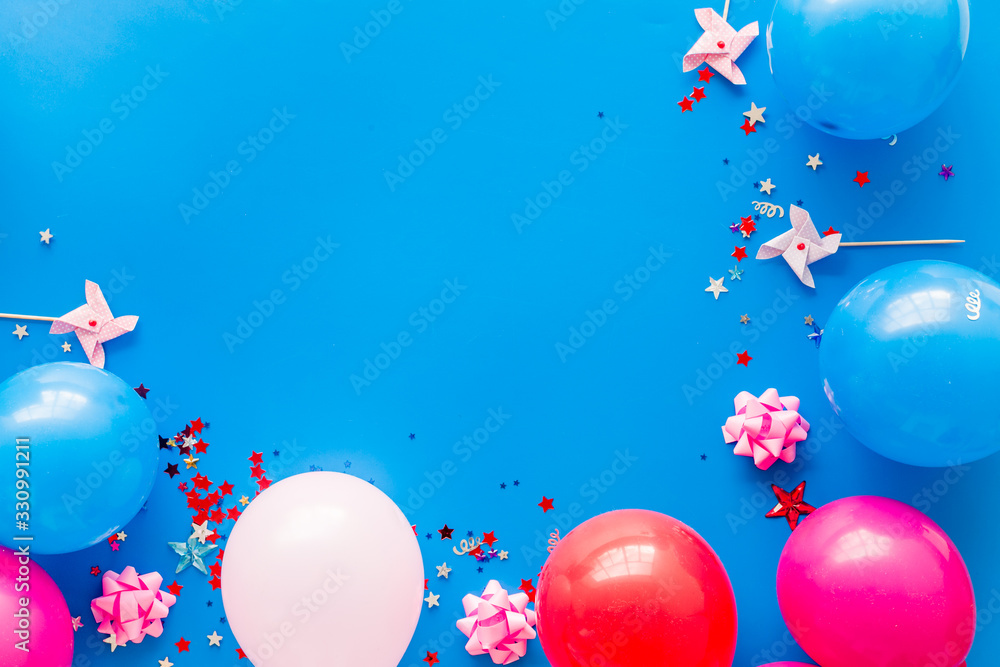 Party concept. Colorful balloons and confetti on blue background top-down frame copy space